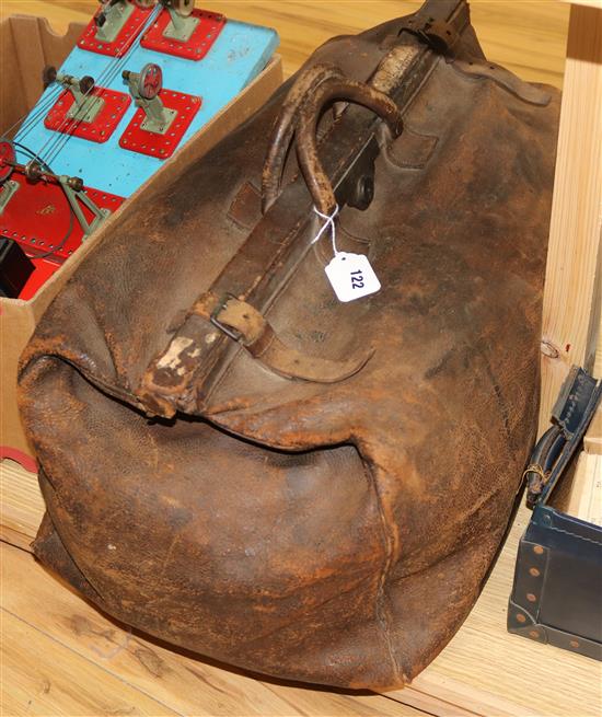 A brown leather Gladstone bag